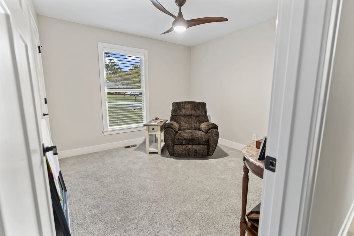 Flex room with new carpet and ceiling fan in a basement renovation in Stilwell, KS
