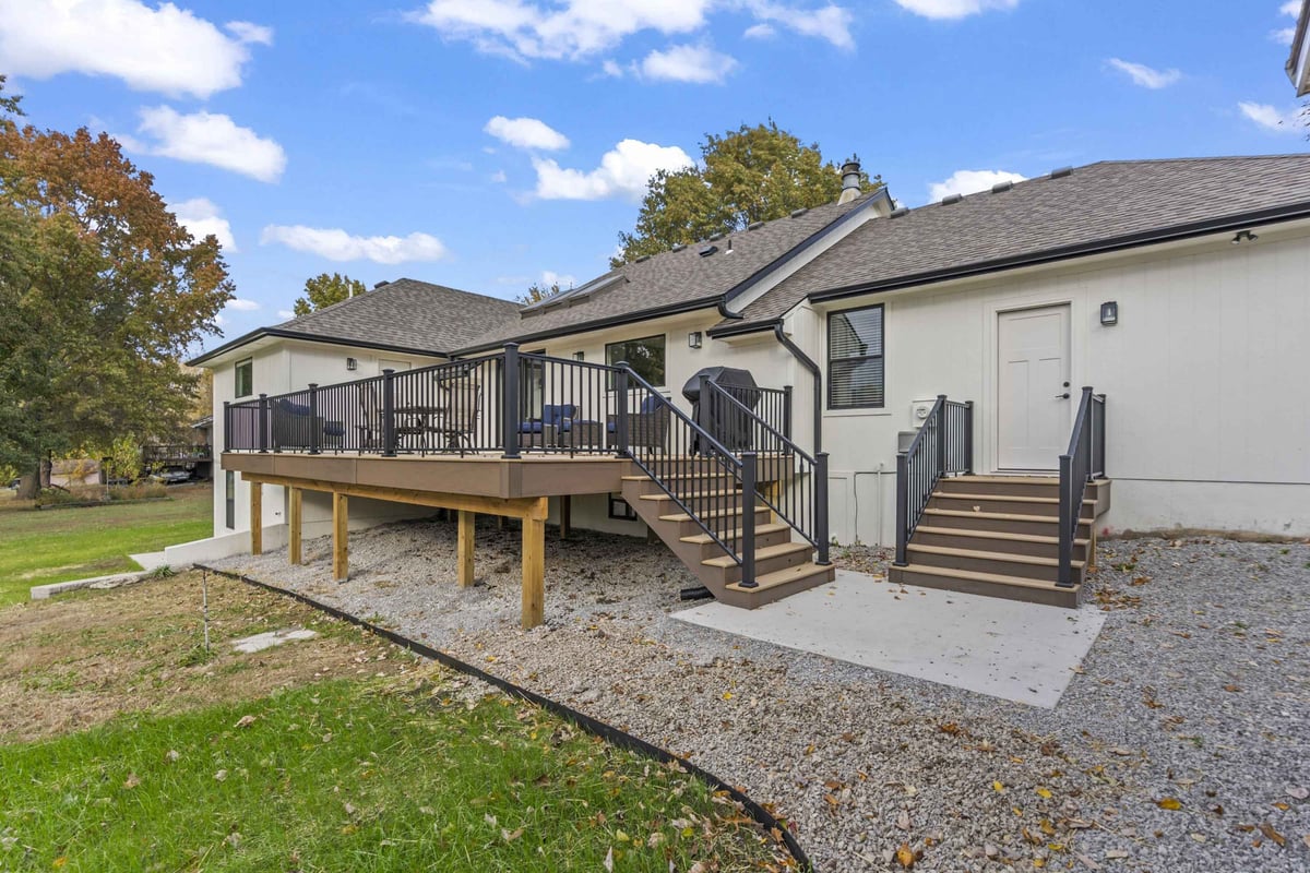 Oversized composite deck remodel in Stilwell, KS featuring low-maintenance decking, integrated lighting, and space for outdoor entertaining.