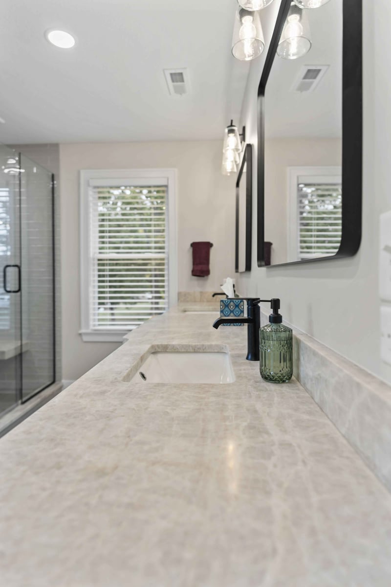 Primary bathroom vanity detail in Stilwell, KS with quartz countertop, undermount sink, and modern faucet.