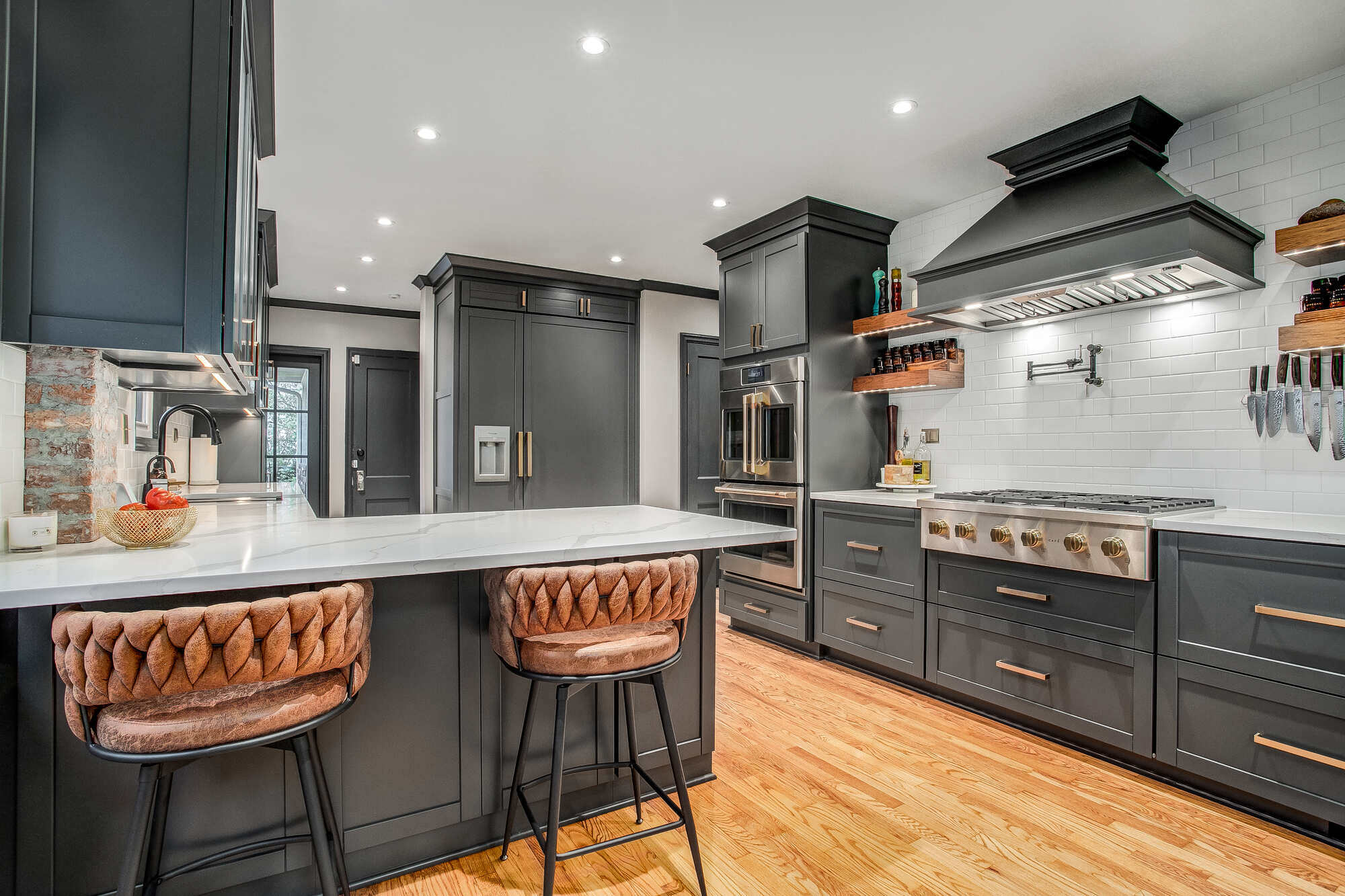 Beautiful kitchen remodel featuring sleek countertops, elegant lighting, and a spacious island