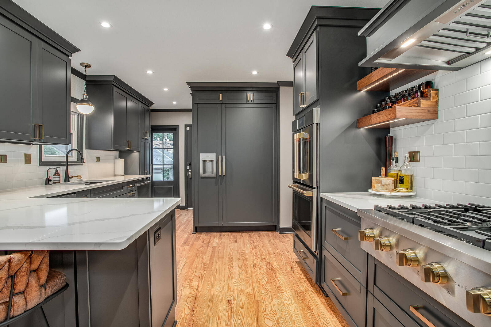 Spacious kitchen with a large island, dark cabinetry, and contemporary finishes, part of a Metro Kansas City remodel