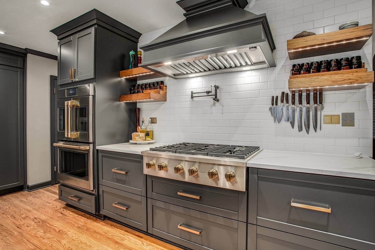 Contemporary chef’s kitchen with sleek cabinetry, a professional gas range, and warm wood accents in Waldo, MO