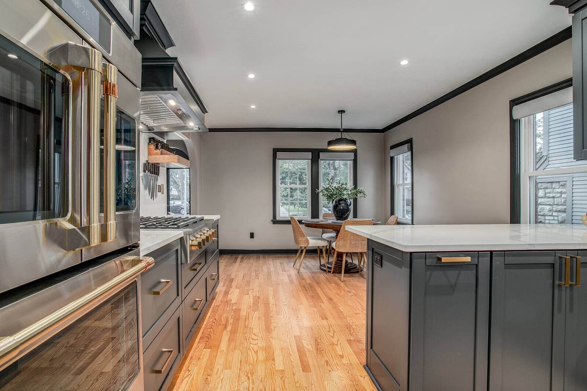 Open-concept kitchen and dining remodel with stylish cabinetry and contemporary lighting in Waldo, MO