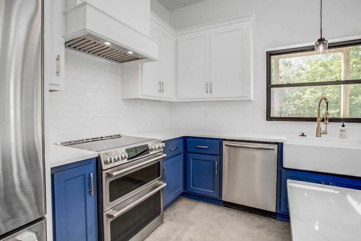 Elegant kitchen with a deep farmhouse sink and contemporary lighting, part of a Metro Kansas City home renovation by Top Shelf Home Builders