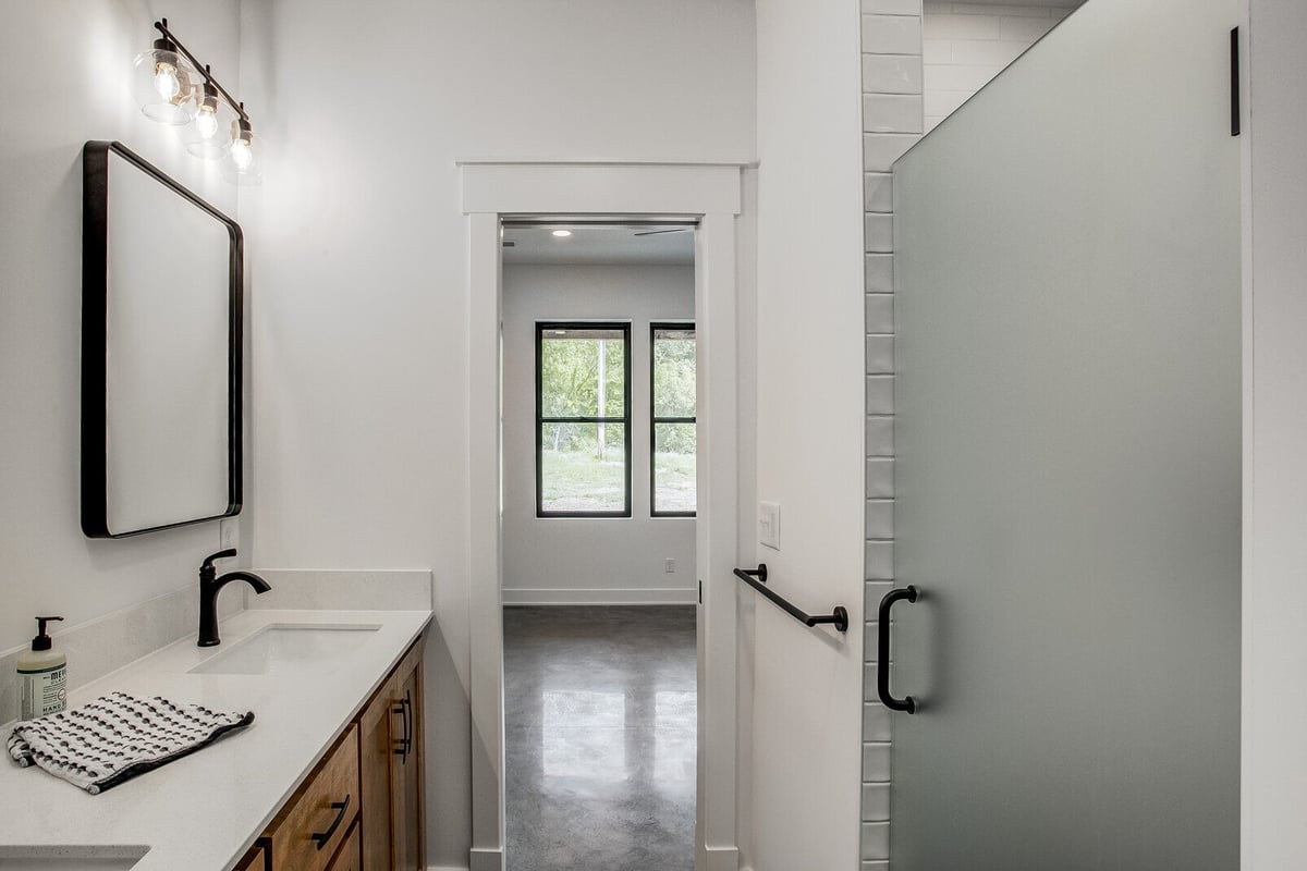 Elegant master bathroom with a frosted glass shower door and dual sinks