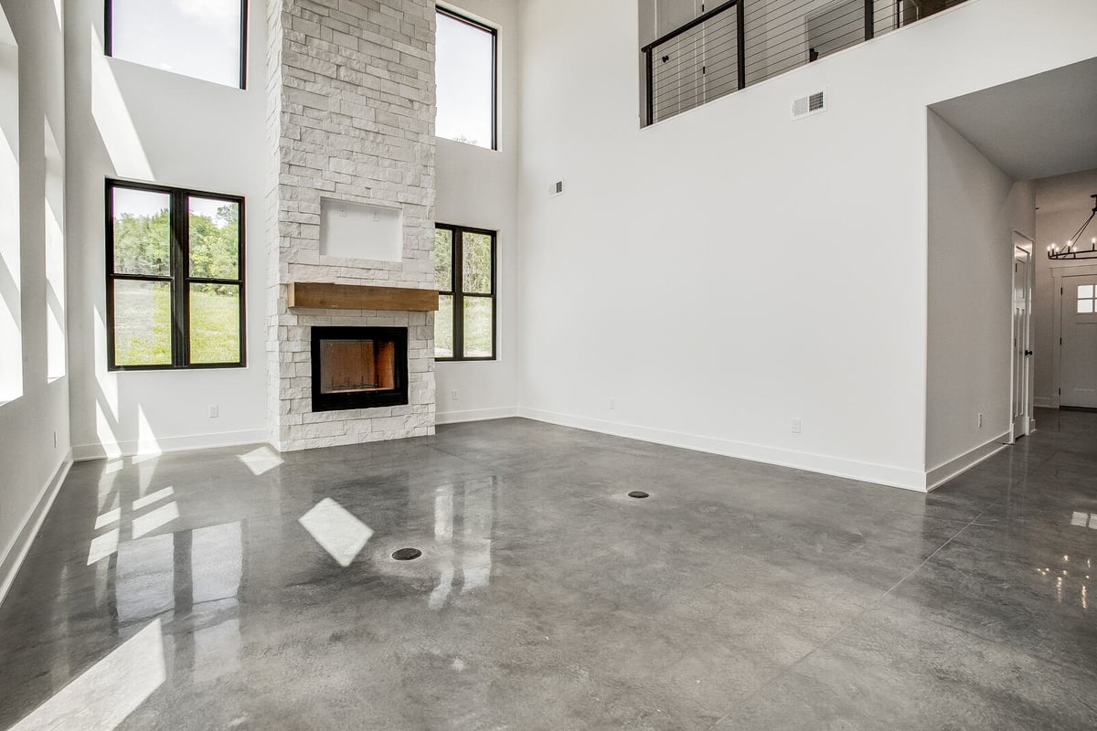 Modern great room with a white stone fireplace and abundant natural light, renovated by Top Shelf Home Builders in Metro Kansas City