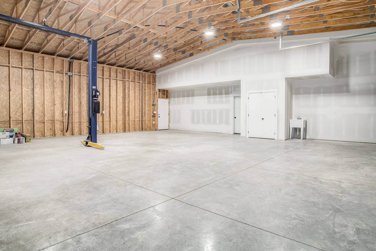 Newly constructed garage workshop with an open layout and exposed wood framing, part of a Metro Kansas City home remodel by Top Shelf Home Builders.jpg