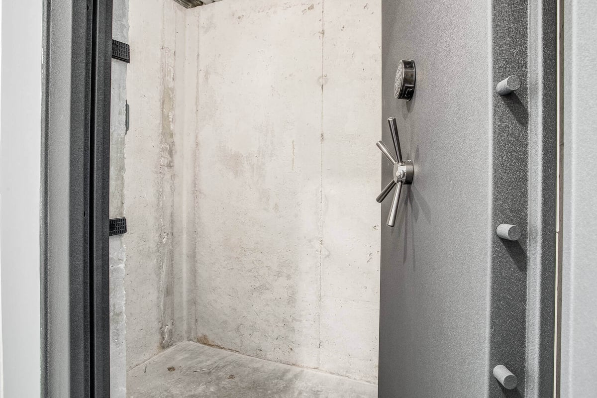 Secure walk-in safe room with a heavy-duty steel door, part of a whole home remodel by Top Shelf Home Builders in Metro Kansas City