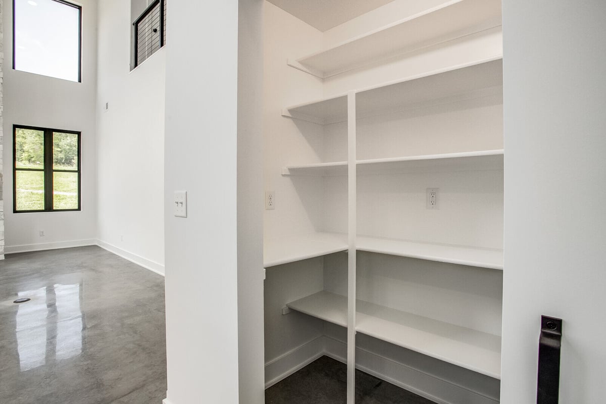 Walk-in pantry with custom built-in shelving, part of a whole home remodel by Top Shelf Home Builders in Metro Kansas City