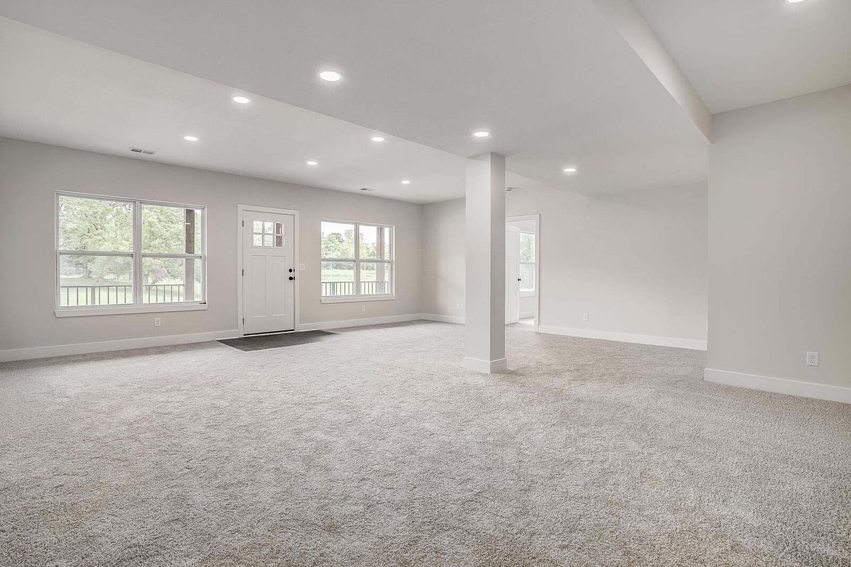 Bright and open living space with large windows, part of a whole home remodel in Kansas City by Top Shelf Home Builders
