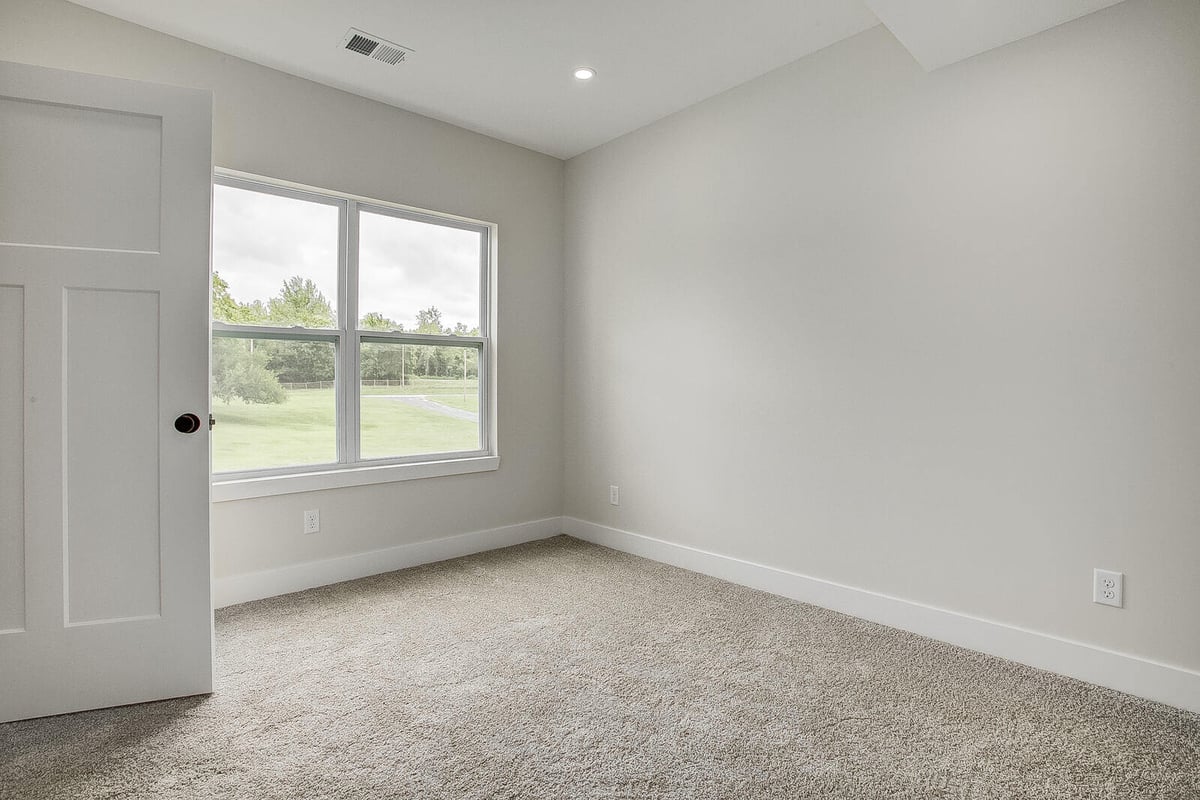 Bright bedroom with large windows, part of a Kansas City whole home remodel by Top Shelf Home Builders