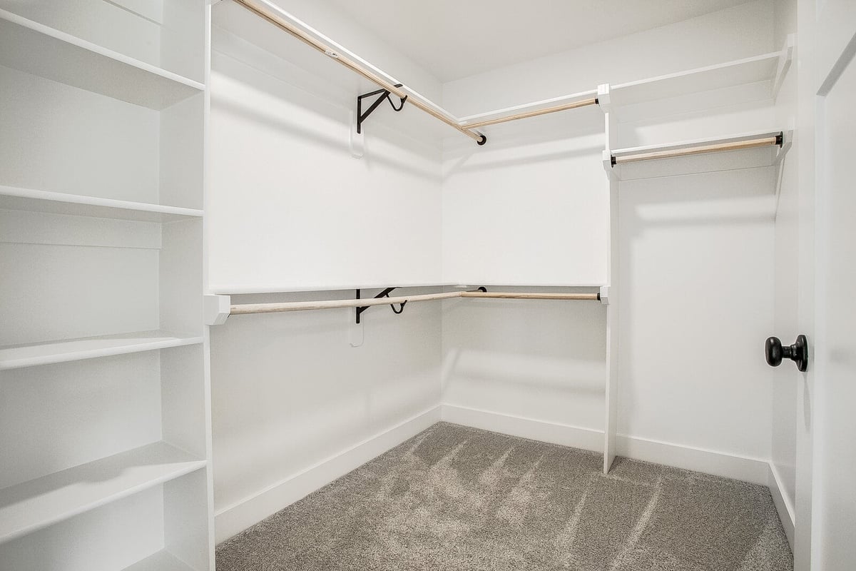Custom walk-in closet with shelving and hanging space, part of a whole home remodel in Metro Kansas City by Top Shelf Home Builders