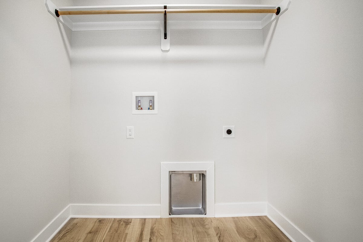 Laundry room setup in a whole home remodel by Top Shelf Home Builders in Metro Kansas City, featuring washer-dryer hookups and a pet washing station.jpg