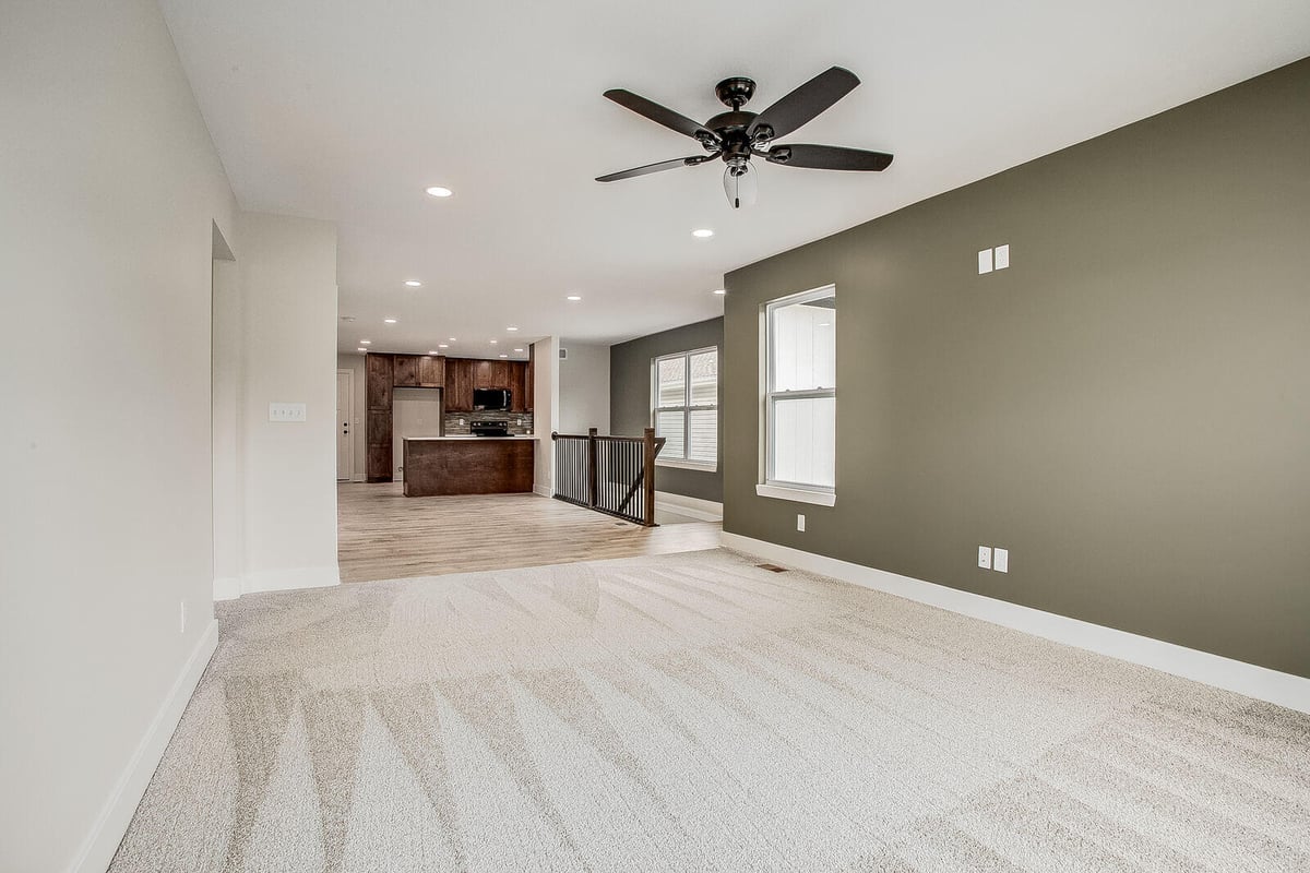 Modern open-concept living room and kitchen in Kansas City, part of a whole home remodel by Top Shelf Home Builders