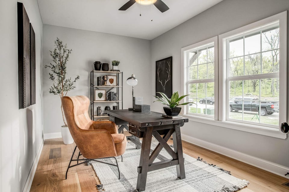 Beautifully designed laundry room featuring built-in cabinets, a woven basket, and natural wood accents in Metro Kansas City