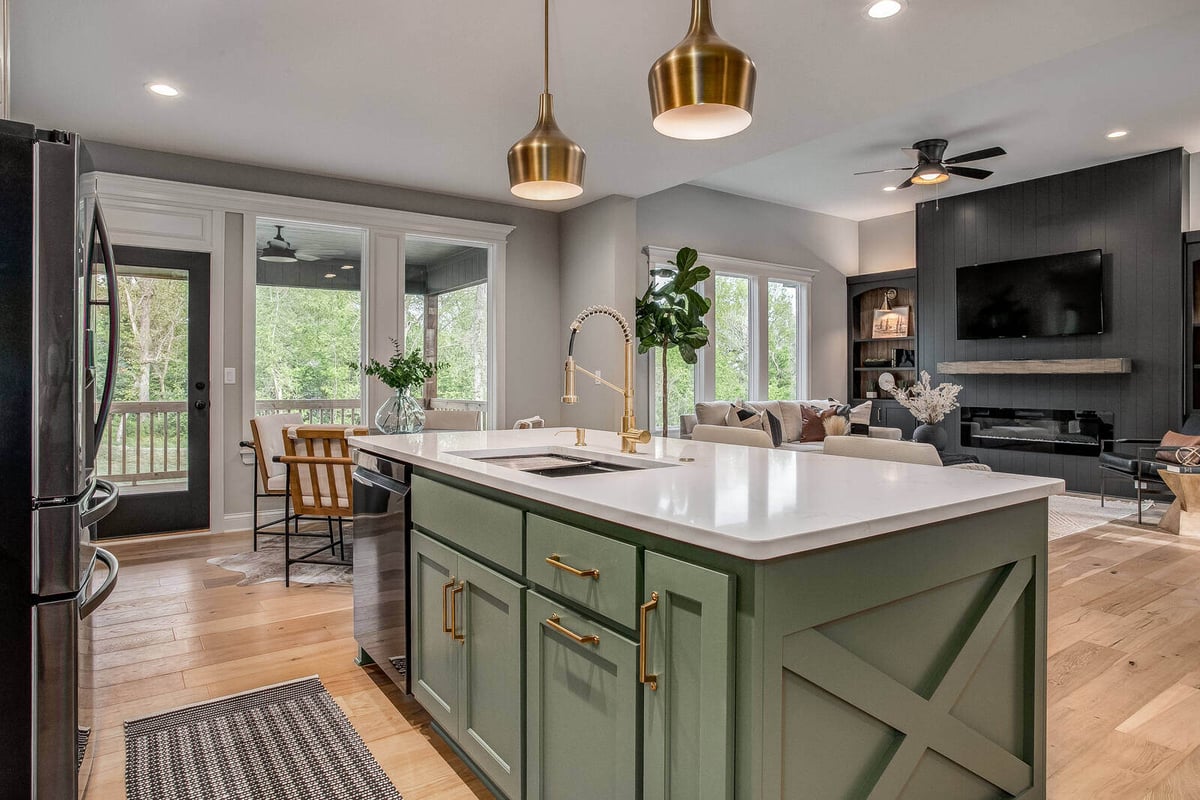 Beautifully remodeled kitchen with a view of the living space and large windows by Top Shelf Home Builders