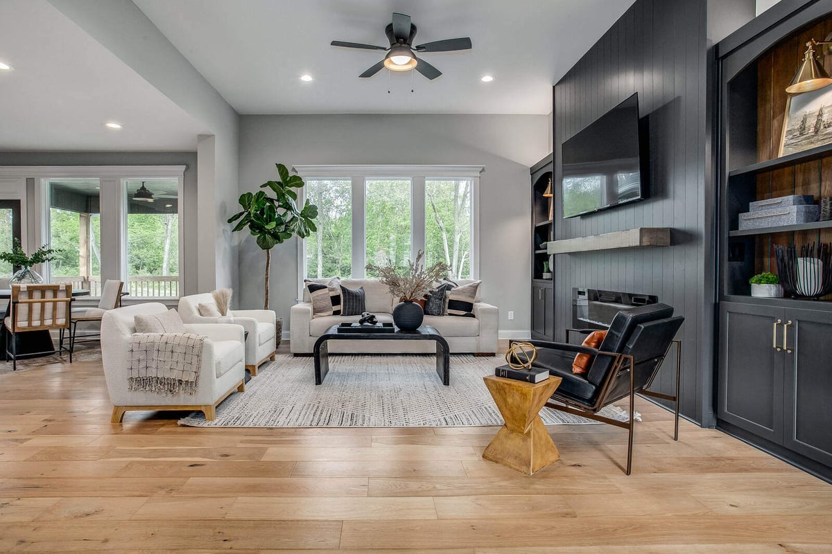 Cozy modern living room with a built-in fireplace, floating shelves, and a black accent wall in Metro Kansas City