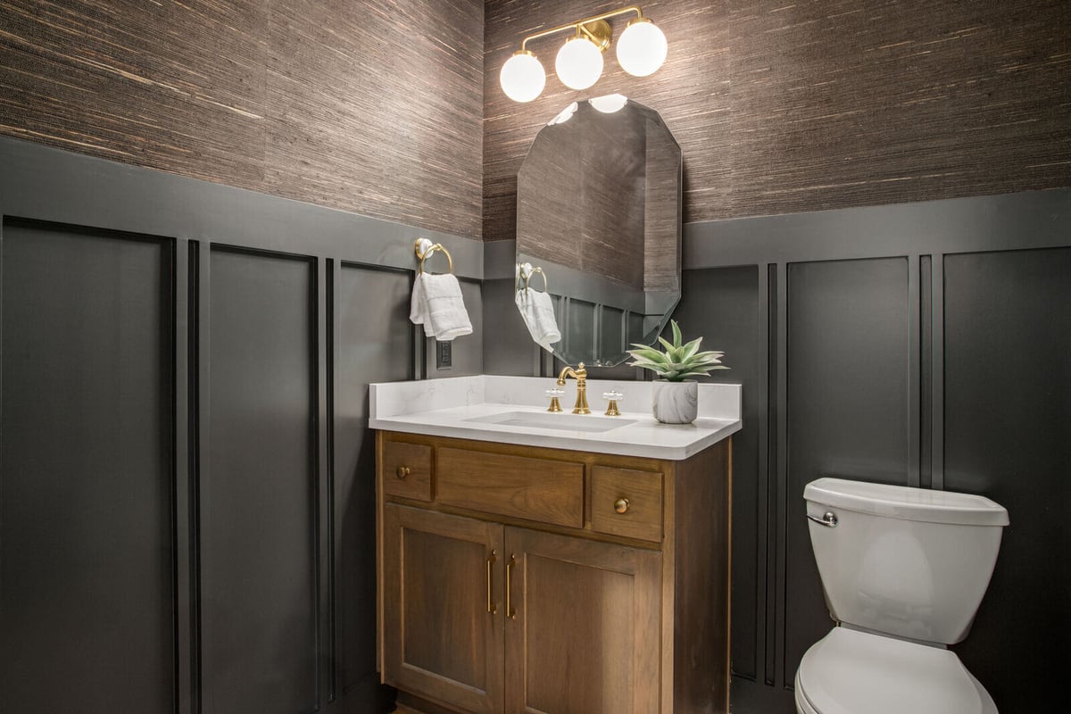 Elegant office space with farmhouse-inspired decor and a black wood desk in a whole home renovation