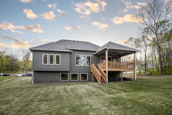 Spacious covered deck overlooking a backyard, part of a whole home remodel by Top Shelf Home Builders